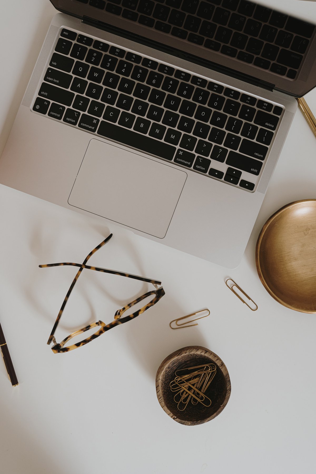 Laptop, Eyeglasses, and Paper Clips Flatlay